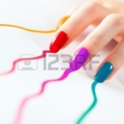 5574428-young-woman-hand-with-multicoloured-nails-on-white